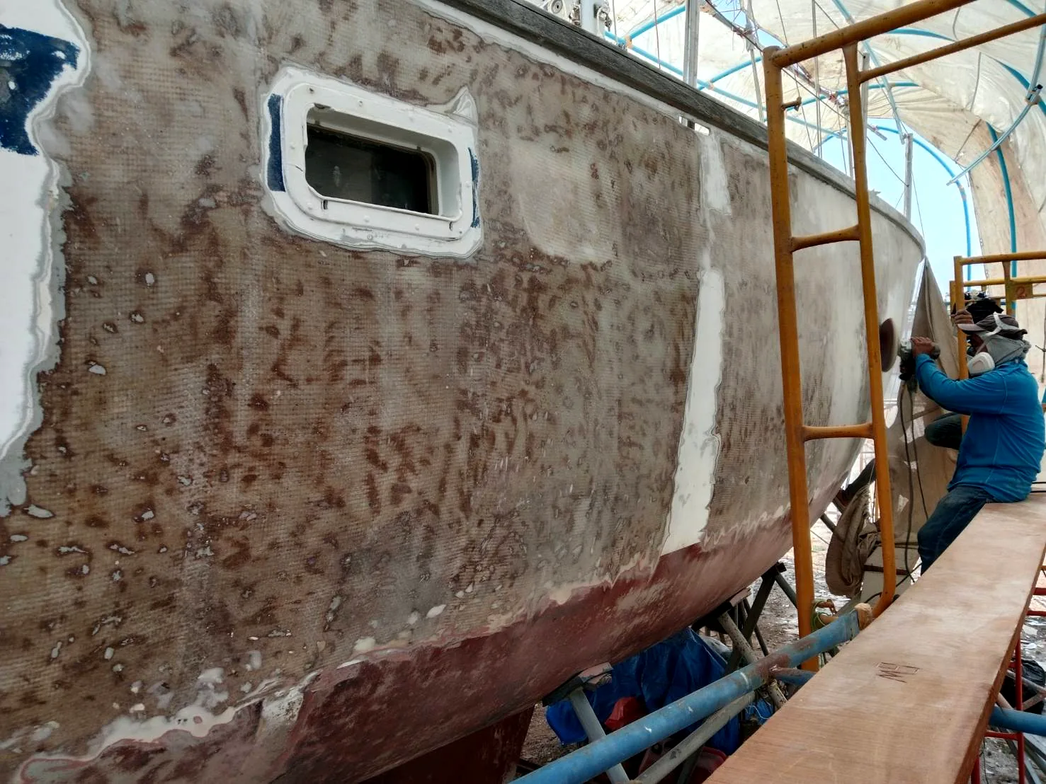 Hull fully stripped showing bare laminate and filler work
